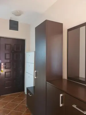 a room with a dresser and a cabinet with a mirror at Belgrade Loft Apartments in Novi Beograd