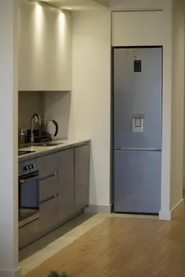 a kitchen with a blue door in a room at Best Apartments-Aqua-Belgrade Waterfront in Belgrade