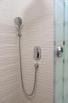 a shower with a shower head on a wall at 1-Bedroom Apartment with Balcony in Ledine