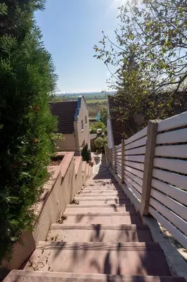 a stairway with a fence next to a house at 1-Bedroom Apartment with Balcony in Ledine