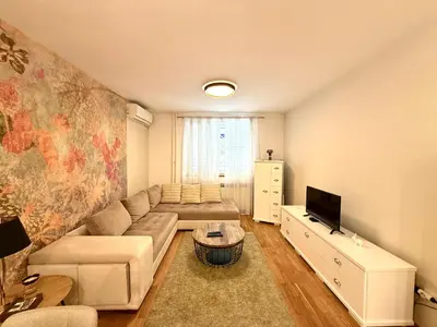 a living room with a couch and a tv at 7 Emperors Central Suite in Belgrade