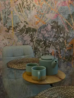a room with a table with cups and a wall at 7 Emperors Central Suite in Belgrade