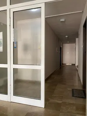a hallway with sliding glass doors in a building at 7 Emperors Central Suite in Belgrade