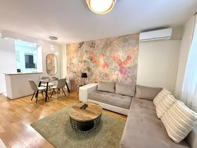 a living room with a couch and a table at 7 Emperors Central Suite in Belgrade