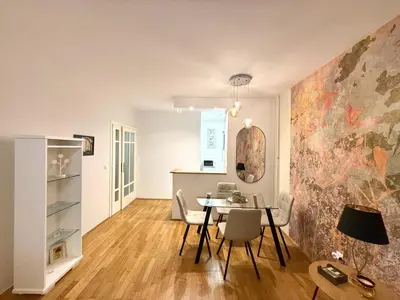 a dining room and kitchen with a table and chairs at 7 Emperors Central Suite in Belgrade