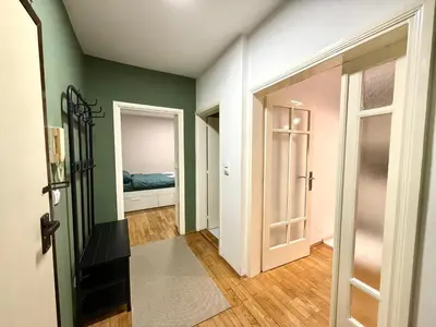 a room with green walls and a bedroom with a bed at 7 Emperors Central Suite in Belgrade