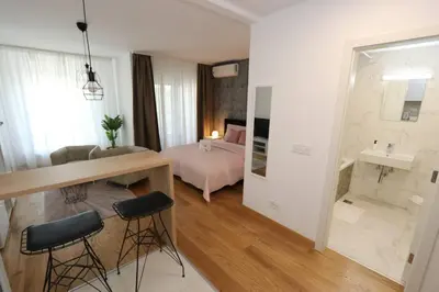 a bedroom with a bed and a table and chairs at Savada PINK - studio with parking and WiFi, parking 5 eur per day in Belgrade