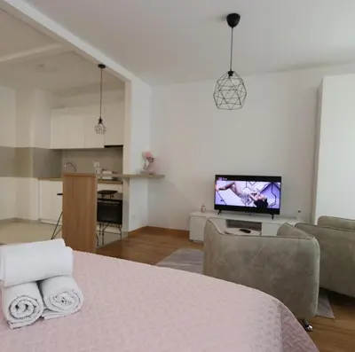 a living room with a table with towels on it at Savada PINK - studio with parking and WiFi, parking 5 eur per day in Belgrade