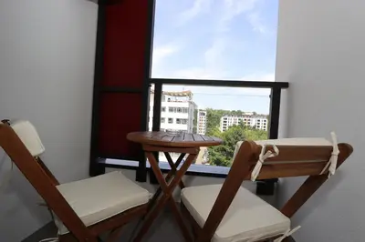 two chairs and a table in a room with a window at Savada PINK - studio with parking and WiFi, parking 5 eur per day in Belgrade