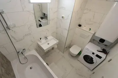 a white bathroom with a toilet and a sink at Savada PINK - studio with parking and WiFi, parking 5 eur per day in Belgrade