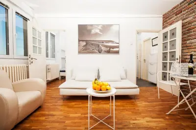 a living room with a couch and a table with fruit on it at Dorcol Rooftop Apartment in Belgrade