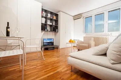 a living room with a couch and a table at Dorcol Rooftop Apartment in Belgrade