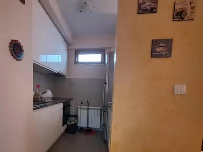 a hallway leading to a kitchen with a window at Amar5 in Belgrade