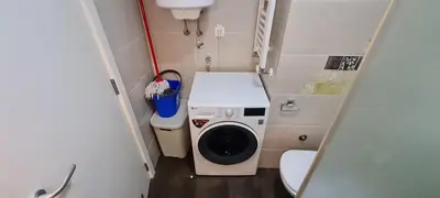 a small bathroom with a washing machine and a toilet at Amar5 in Belgrade