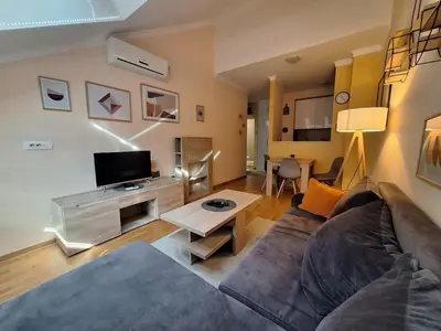 a living room with a couch and a tv at Amar5 in Belgrade