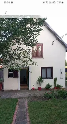 a white house with a door and a window at Surcin center house in Surčin