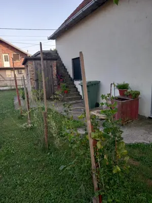 a fence in a yard next to a house at Surcin center house in Surčin