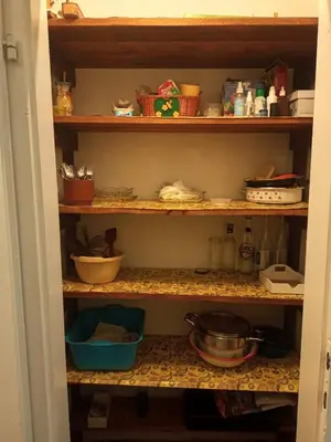 a kitchen pantry with bowls and dishes on shelves at Surcin center house in Surčin