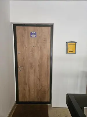 a wooden door with a sign on it in a room at BeGreat in Belgrade