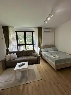 a living room with a couch and a table at BeGreat in Belgrade