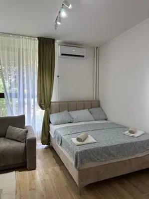 a bedroom with a bed and a couch at BeGreat in Belgrade