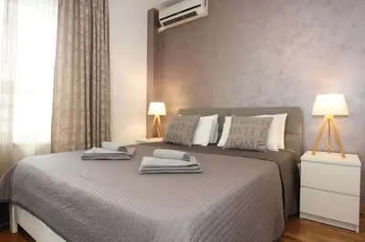 a bedroom with a bed with towels on it at Kokpit - Stan Na Dan Novi Beograd Belvil, parking 5 evra dan in Belgrade