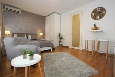a living room with a couch and a bed at Kokpit - Stan Na Dan Novi Beograd Belvil, parking 5 evra dan in Belgrade