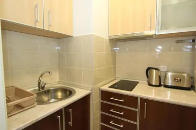 a small kitchen with a sink and a counter top at Kokpit - Stan Na Dan Novi Beograd Belvil, parking 5 evra dan in Belgrade