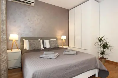 a bedroom with a bed with two towels on it at Kokpit - Stan Na Dan Novi Beograd Belvil, parking 5 evra dan in Belgrade