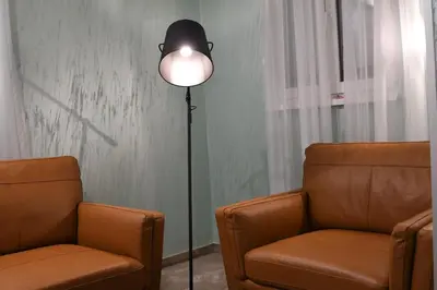 a room with two chairs and a floor lamp with a lamp at KAME HOTEL BELGRADE,\u8d1d\u5c14\u683c\u83b1\u5fb7\u51ef\u7f8e\u9152\u5e97 in Ledine