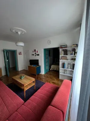 a living room with a red couch and a table at Queen of the arts in Belgrade