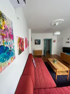 a living room with a red couch and a table at Queen of the arts in Belgrade