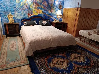 a bedroom with a bed with a painting on the wall at Maravilja in Filmski Grad