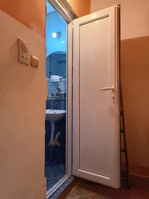a door leading into a bathroom with a sink at Maravilja in Filmski Grad