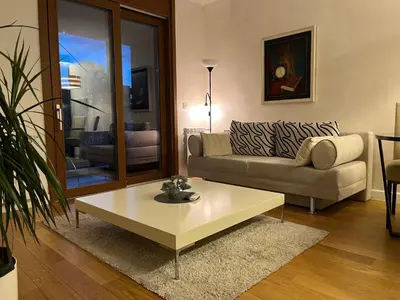 a living room with a couch and a coffee table at THE FIVE-New Belgrade Apartment in Belgrade