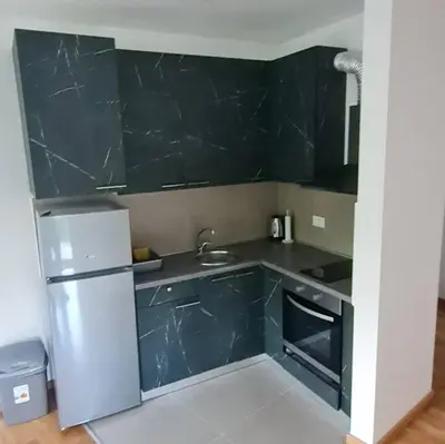 a small kitchen with a sink and a refrigerator at Amar 4 in Zemun