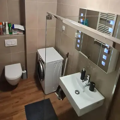 a bathroom with a sink and a toilet and a mirror at Amar 4 in Zemun