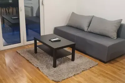 a living room with a couch and a coffee table at Amar 4 in Zemun