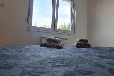 a bedroom with a bed with two pillows on it at Amar 4 in Zemun