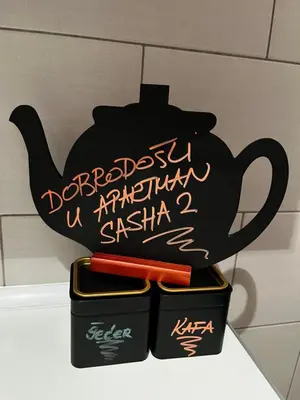a teapot and two containers with writing on it at Apartman Sasha 2 in Belgrade