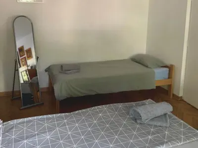 a small room with two beds and a mirror at Apartman Sasha 2 in Belgrade