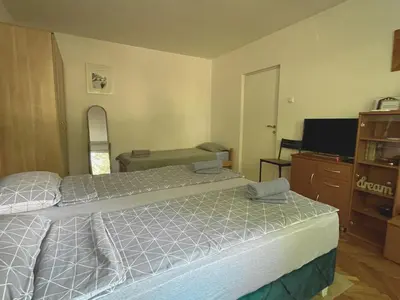 a hotel room with two beds and a television at Apartman Sasha 2 in Belgrade