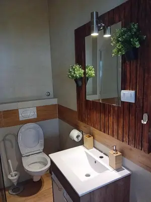 a bathroom with a toilet and a sink with a mirror at Apartman centar SD in Smederevo