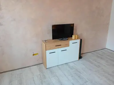 a flat screen tv sitting on top of a cabinet at Apartman centar SD in Smederevo