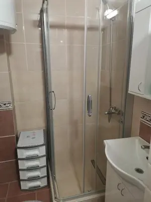 a shower with a glass door in a bathroom at Topli Dom Obrenovac in Obrenovac
