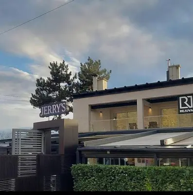 a building with a sign on top of it at Apartman Elena Dedinje in Belgrade