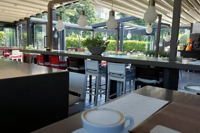 a bar with a cup of coffee on a table at Apartman Elena Dedinje in Belgrade