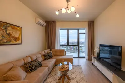 a living room with a couch and a flat screen tv at Belgrade Waterfront Residences - Beograd na vodi in Belgrade