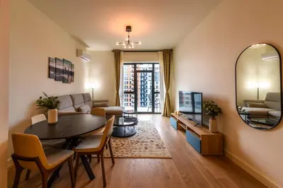 a living room with a table and a couch and a mirror at Belgrade Waterfront Residences - Beograd na vodi in Belgrade