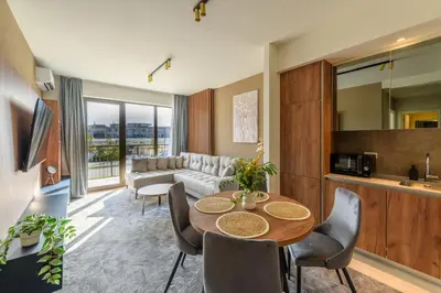 a living room with a table and a couch at Belgrade Waterfront Residences - Beograd na vodi in Belgrade